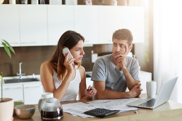 Young couple checking their family budget