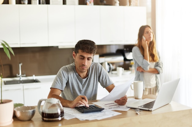 Young couple checking their family budget