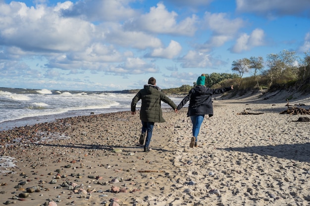 Free photo young couple of the cold baltic sea