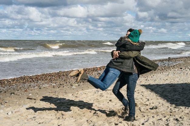 Free Photo young couple of the cold baltic sea