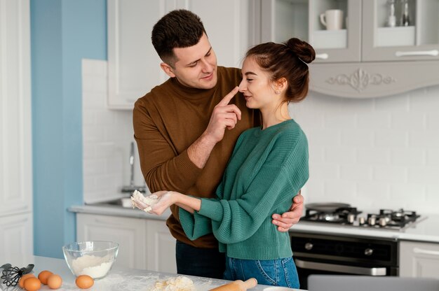 Young couple cooking at home