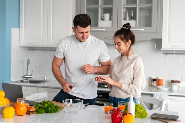 Young couple cooking at home