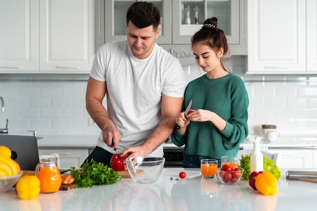 Young couple cooking at home