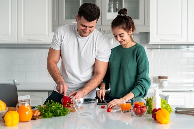 Young couple cooking at home