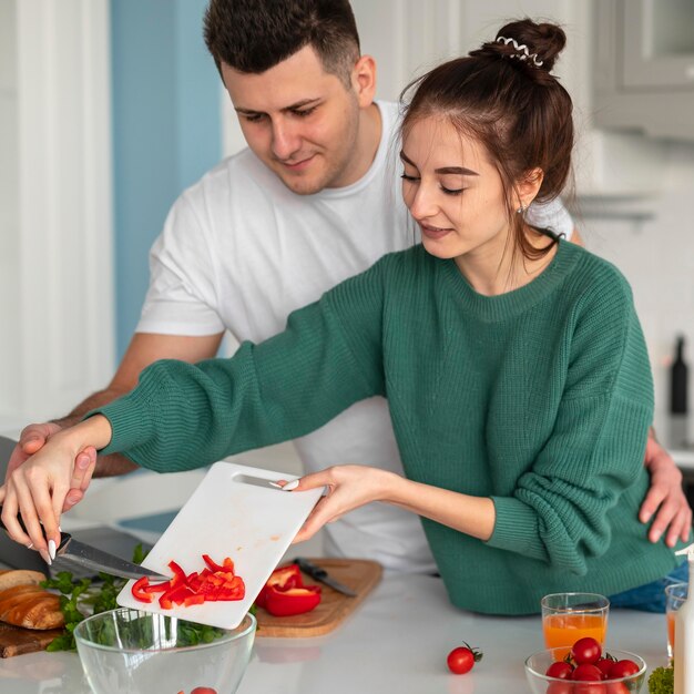 Young couple cooking at home