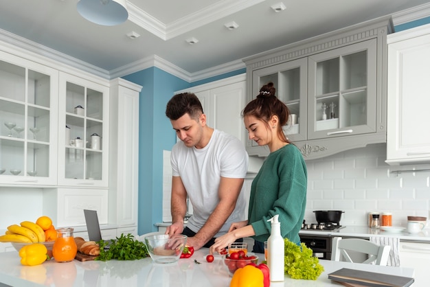 Free photo young couple cooking at home