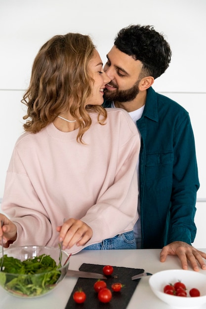 Young couple cooking together at home