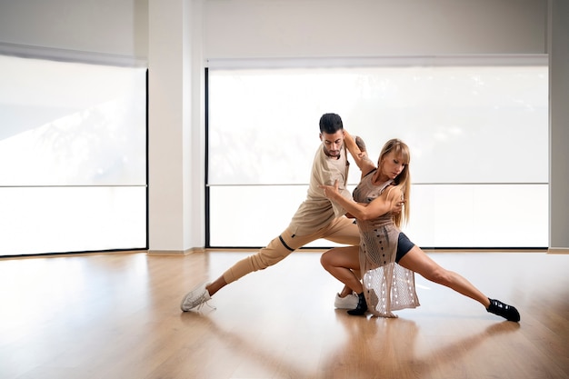 Free Photo young couple dancing bachata