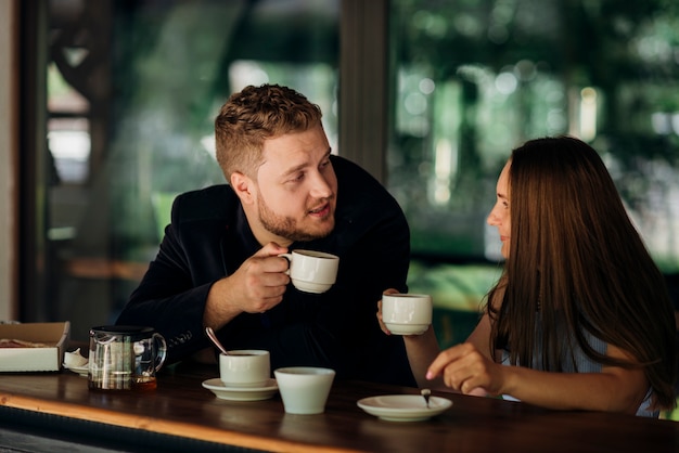 Young couple drinking tea in cafe