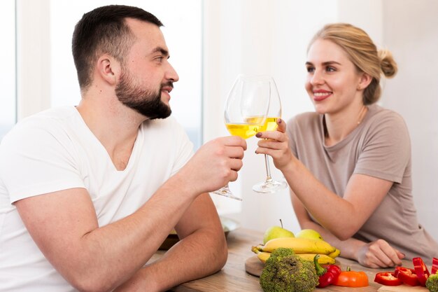 Young couple eating vegetables and drinking together