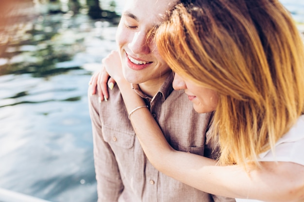 Free Photo young couple embracing at water