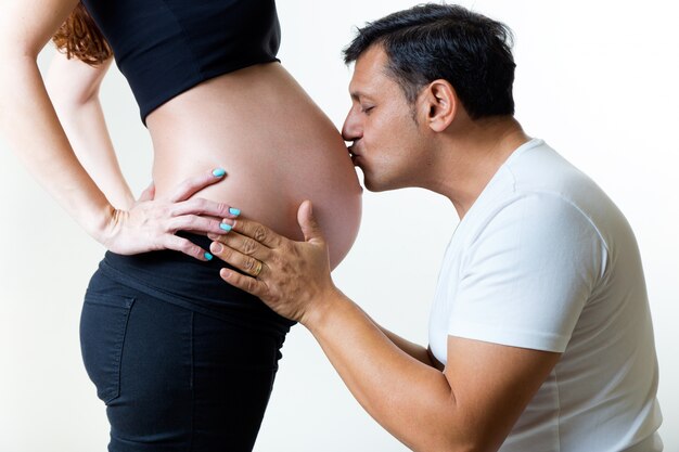 Young couple expecting baby. Isolated on white.