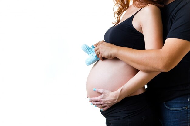 Young couple expecting baby. Isolated on white.