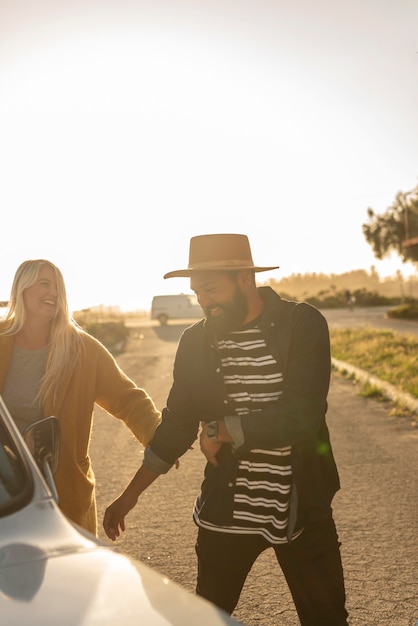 Free photo young couple fooling around on their car trip