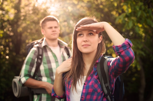 Young couple in forest at sunset