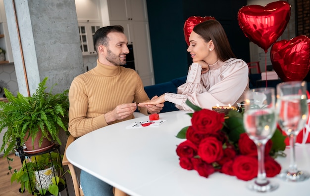 Free photo young couple getting engaged on valentines day