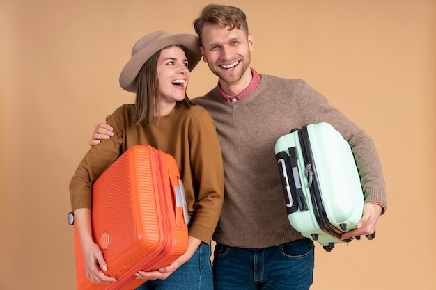 Free photo young couple getting ready for traveling with luggage