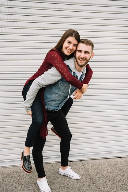 Young couple having fun in front of garage