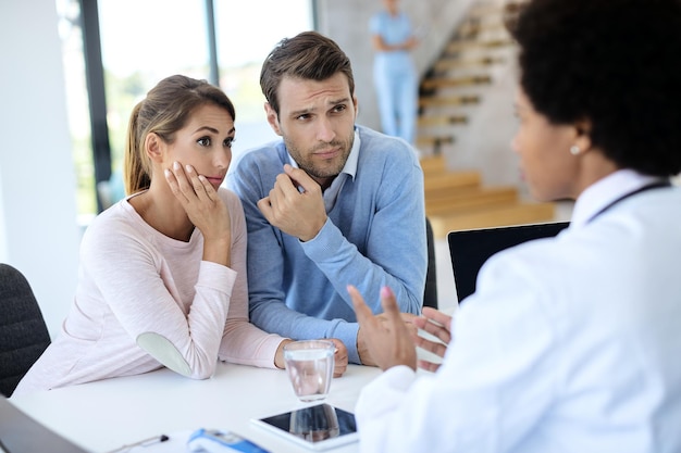 Free photo young couple having medical counseling with a doctor at the clinic