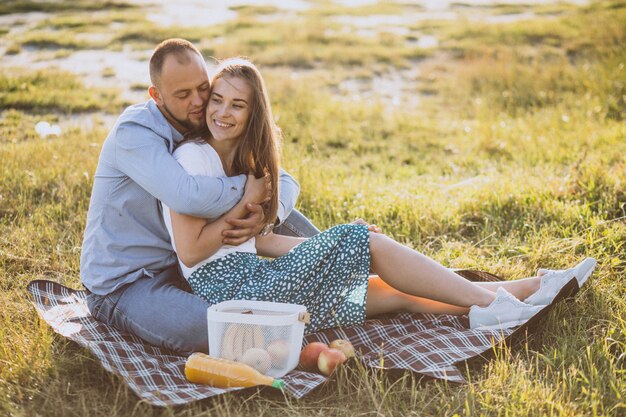 Young couple having picnic in park