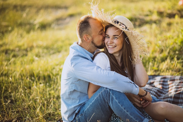 Young couple having picnic in park