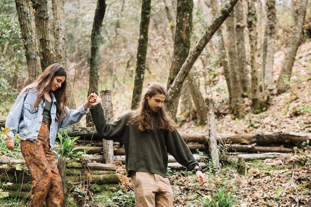 Free photo young couple hiking in forest