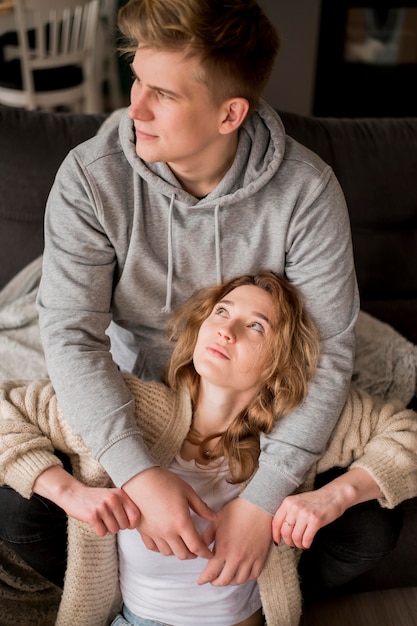 Young couple at home hugging