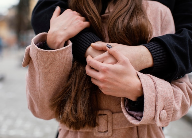 Young couple hugging close up