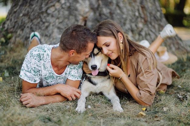 Young couple and husky