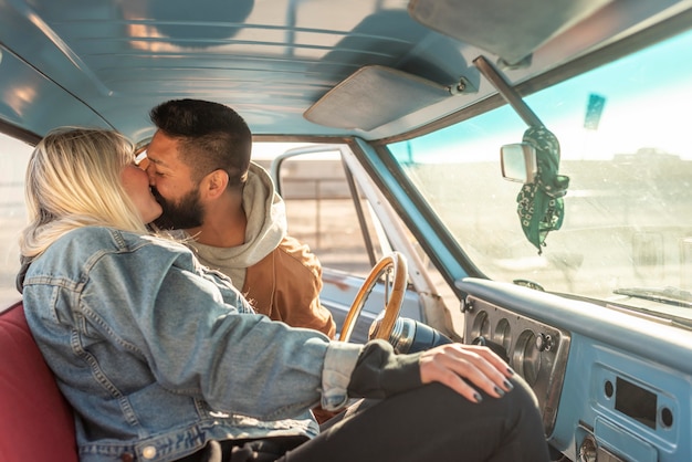 Young couple kissing in their car