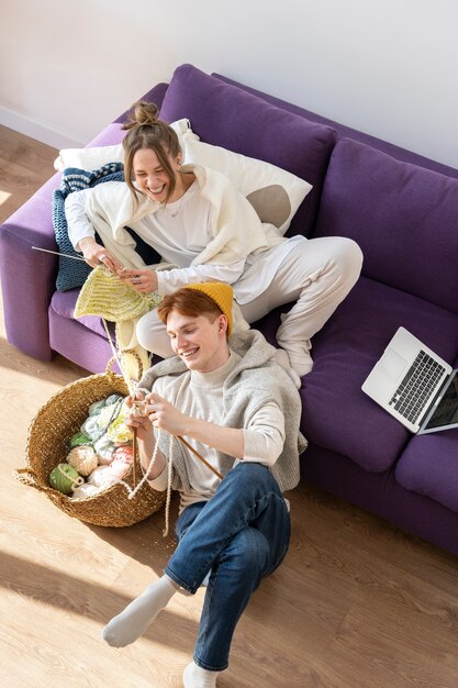 Young couple knitting together