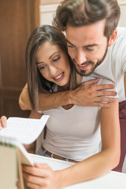 Young couple looking at notebook