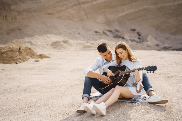 Young couple in love, boyfriend playing the guitar