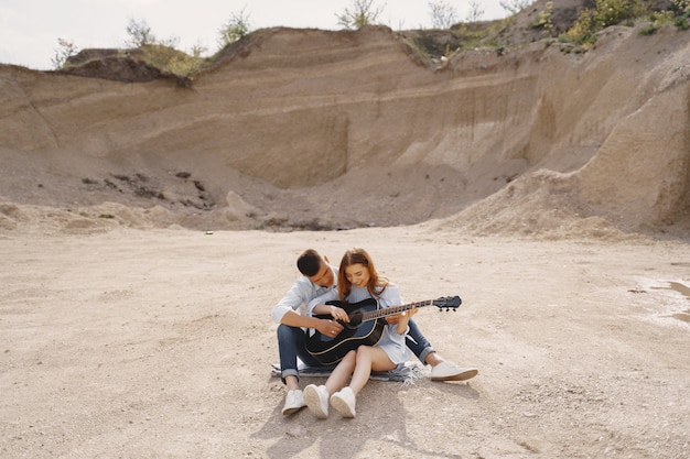 Young couple in love, boyfriend playing the guitar