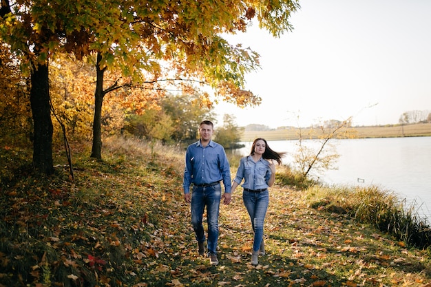 Free Photo young couple in love. a love story in the autumn forest park