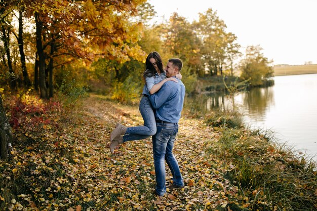 Young couple in love. A love story in the autumn forest park