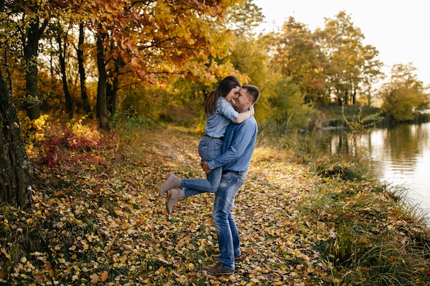 Young couple in love. A love story in the autumn forest park