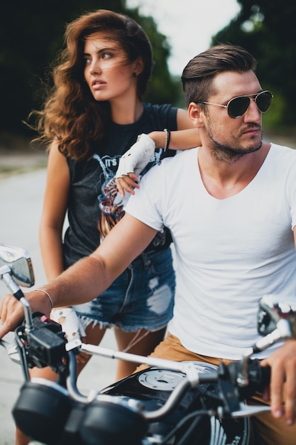 Free photo young couple in love on a motorcycle