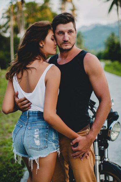 Young couple in love near a motorcycle