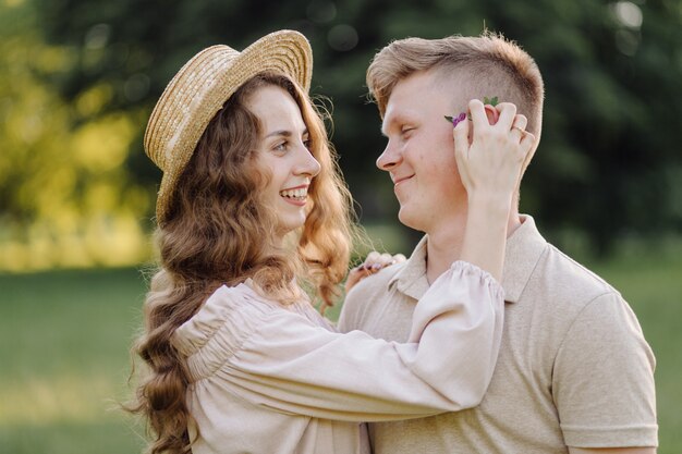 Young couple in love outdoor.Stunning sensual outdoor portrait of young stylish fashion couple posing in summer in field