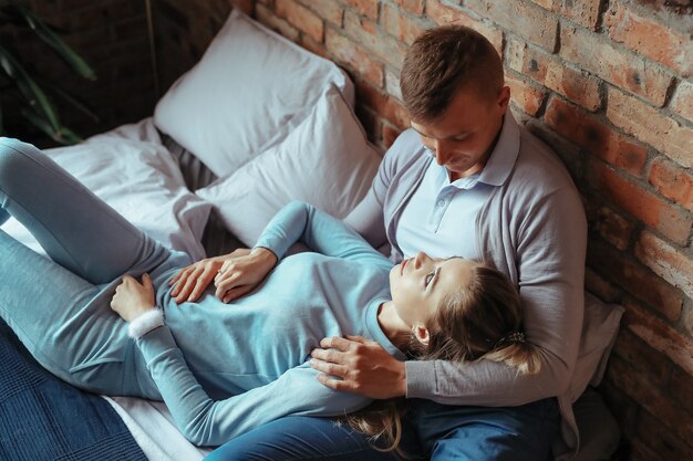 Young couple in love spending time together. Beautiful woman and handsome man having intimate moments at home