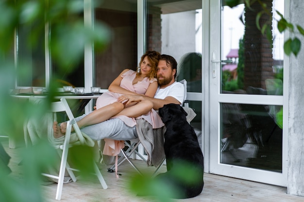 Young couple in love on the terrace of their home.