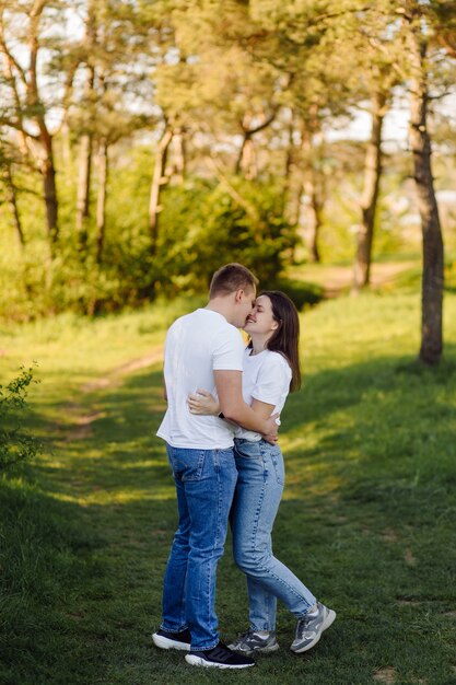 A young couple in love walks in the woods, having a good time together