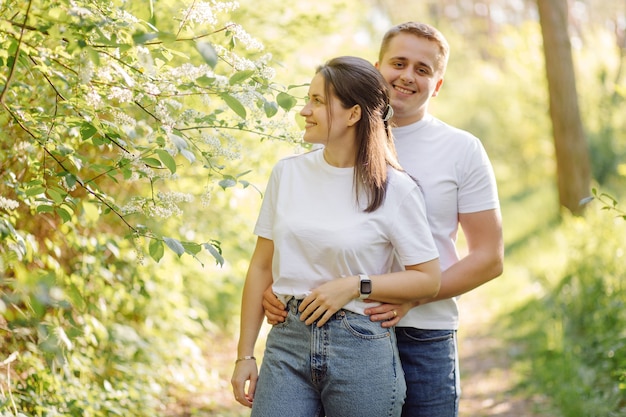 A young couple in love walks in the woods, having a good time together