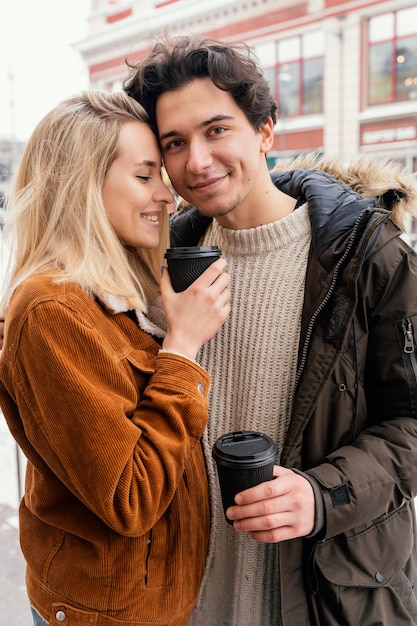 Young couple outdoor enjoying cup of coffee