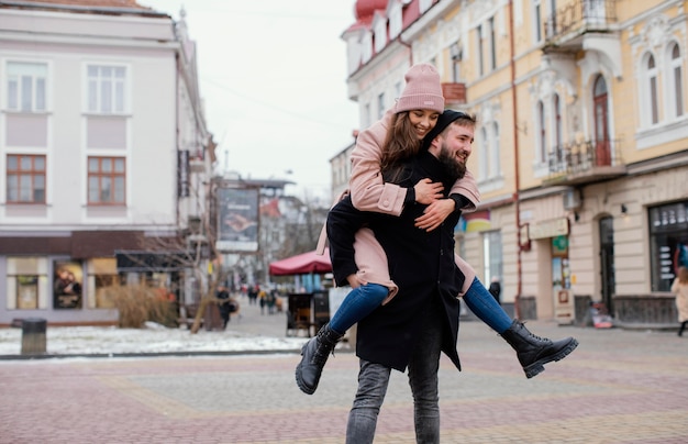 Young couple piggy back ride