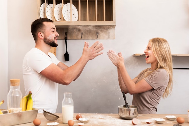 Free photo young couple playing in the kitchen