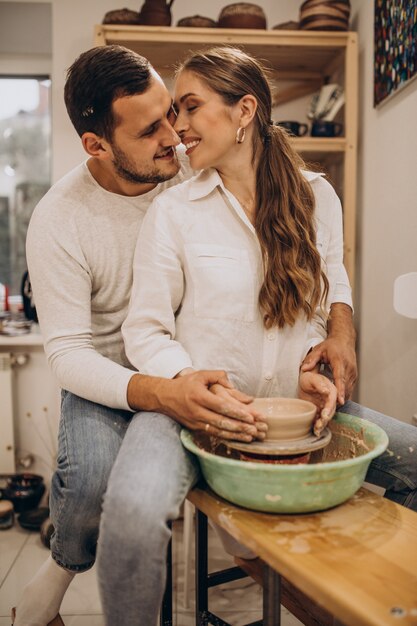 Young couple at a pottery class together