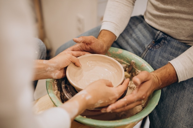 Young couple at a pottery class together