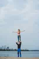 Free photo young couple practicing yoga on city background